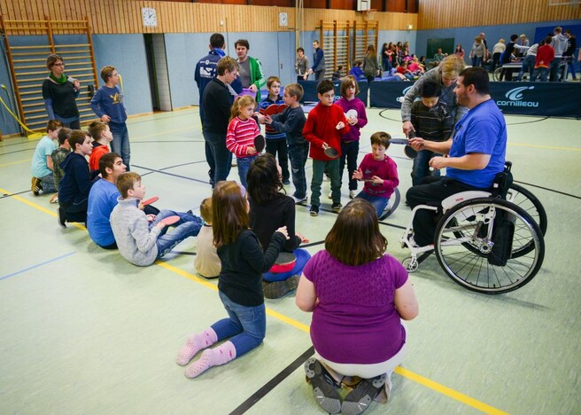 Selcuk Cetin zeigt den Schülerinnen und Schülern der Pestalozzischule die Grundtechniken im Tischtennis